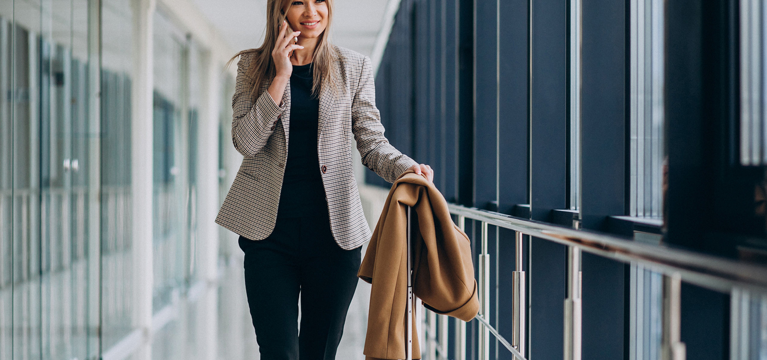 Business woman terminal with travel bag talking phone