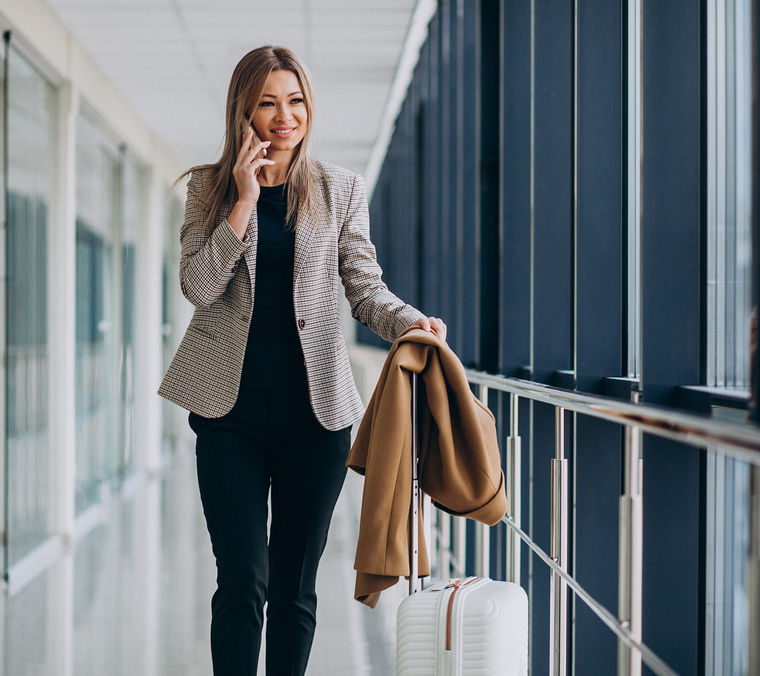 Business woman terminal with travel bag talking phone