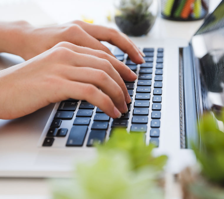 Close up hands typing keyboard