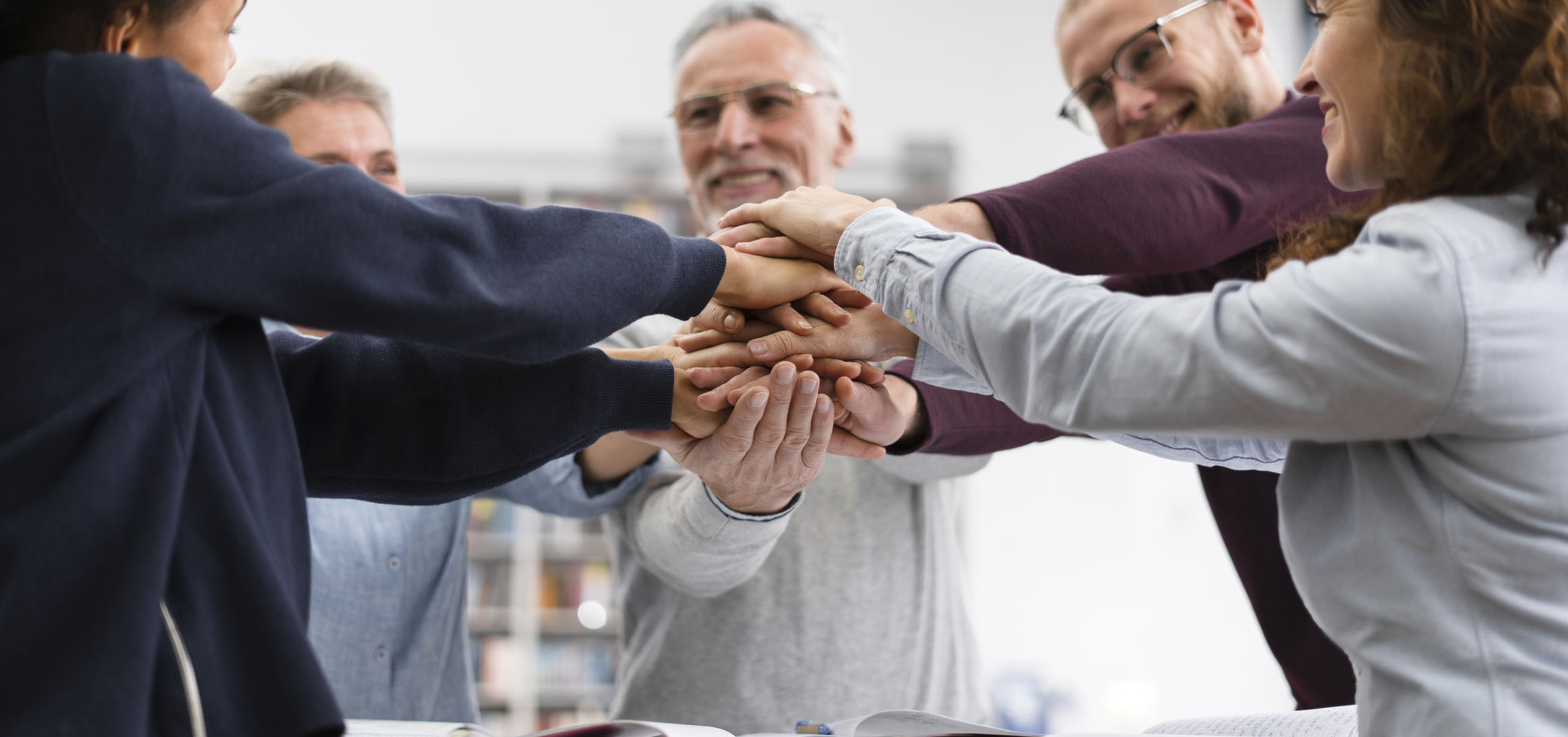 Close up people holding hands together