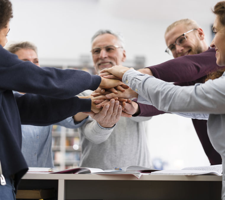 Close up people holding hands together