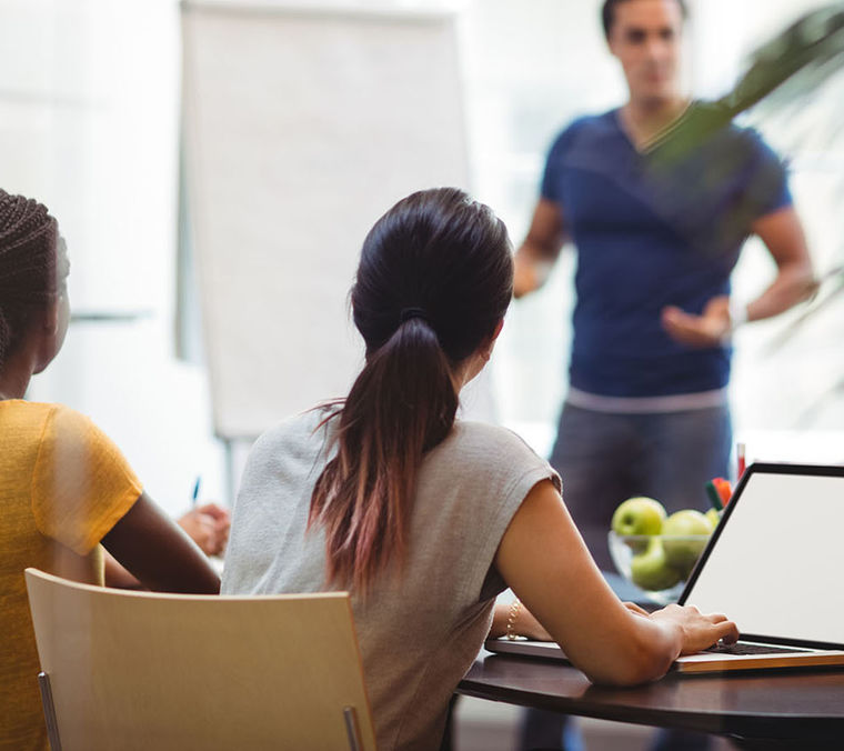 Business executives using laptop Cropped