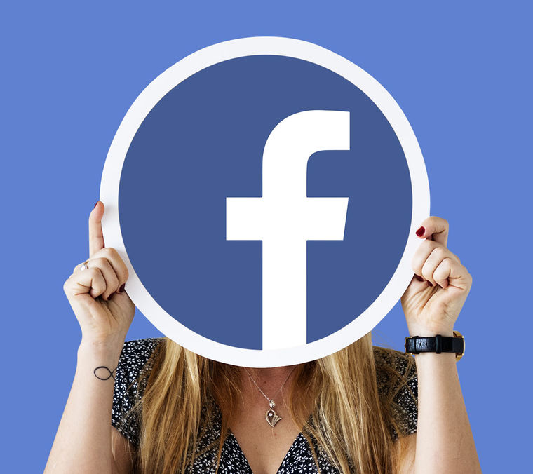 Woman showing facebook icon Cropped
